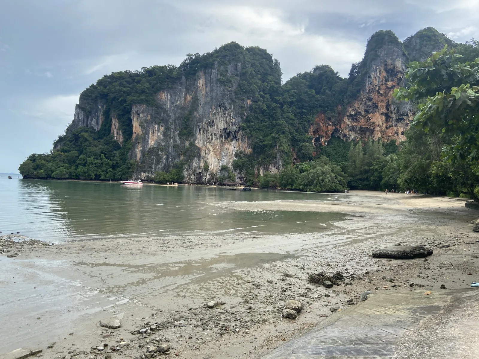 Limestone cliffs above a sheltered bay at low tide in Thailand